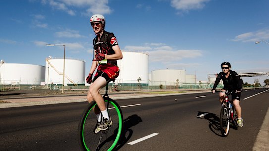 Riders pass silos on Kororoit Creek Road, Williamstown North in the 2014 MS Melbourne Cycle.