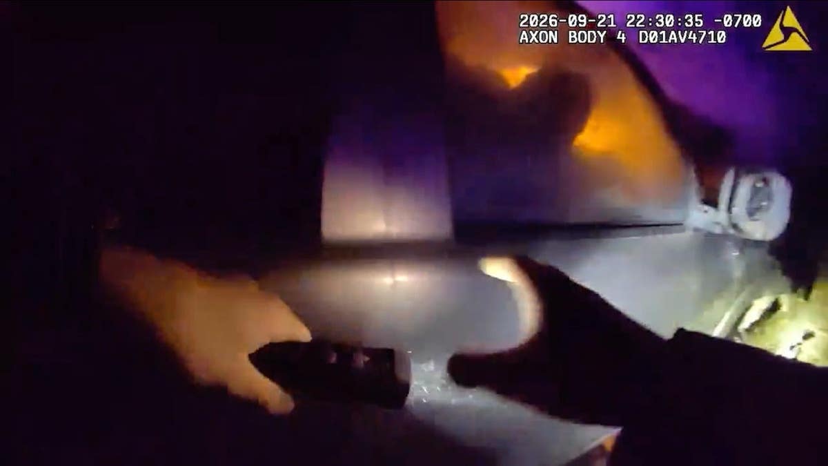 The sheriff's deputy moves to the passenger side door