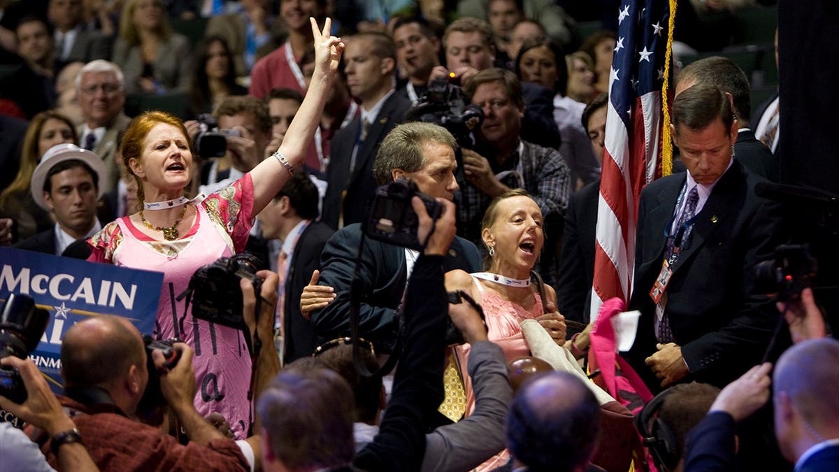 Jodie Evans and Medea Benjamin protest during a John McCain campaign event in 2008.