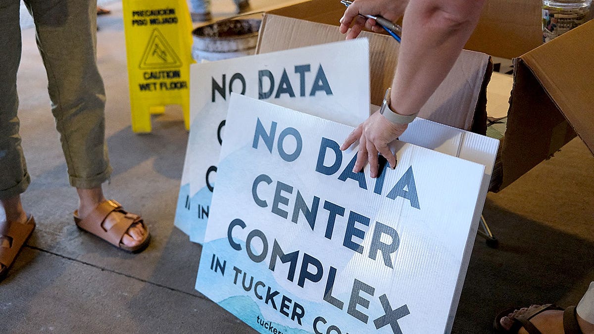 Volunteers distribute yard signs opposing a data center project in Canaan Valley, W.Va.