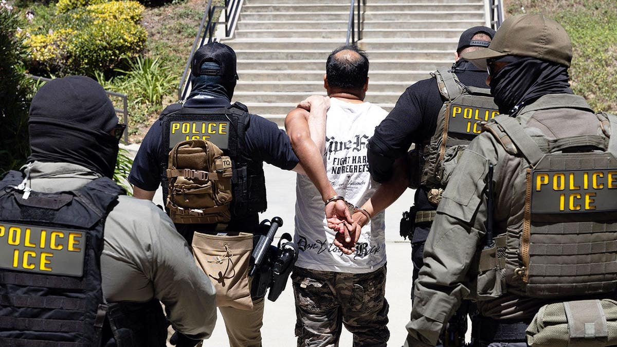 ICE agents walk a detainee out of the Ventura County Government Center in Ventura, California.