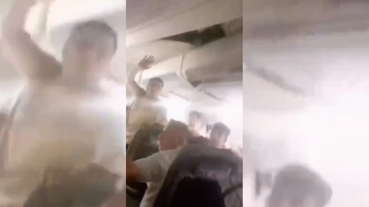 Passengers reacting inside damaged plane cabin.