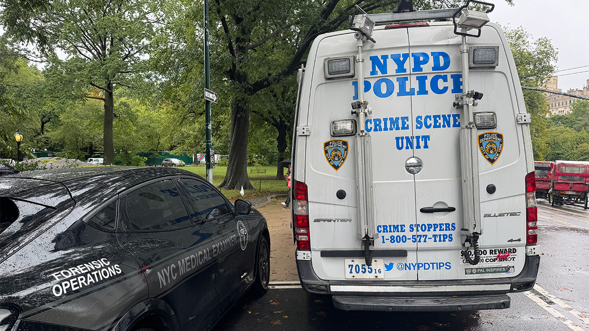 An NYPD Crime Scene Unit van and NYC medical examiner vehicle are parked near Central Park