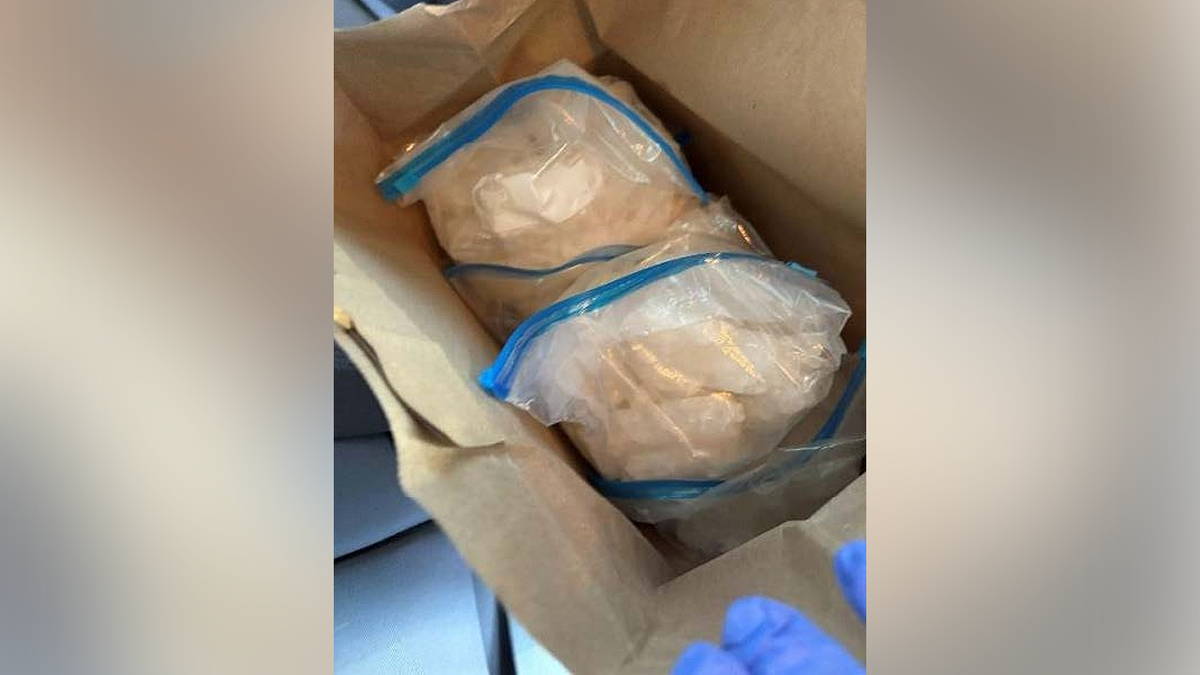 Plastic bags containing suspected methamphetamine inside a paper bag