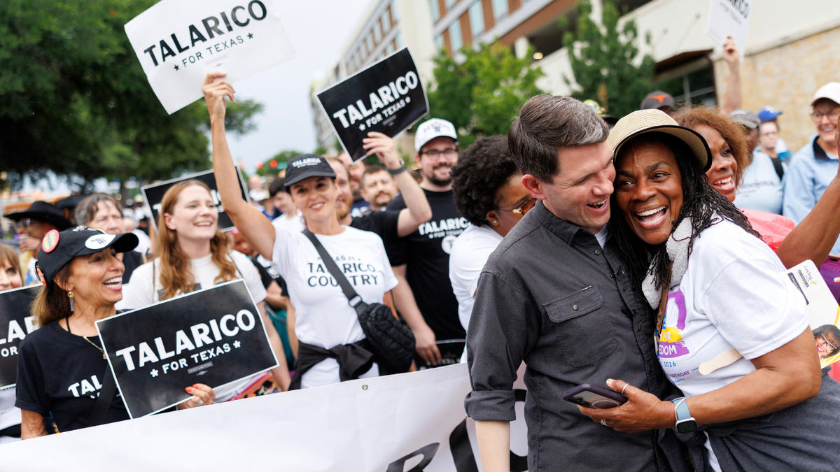 State Representative James Talarico, a Democrat from Texas and U.S. Senate candidate, is hugged by a supporter during a Juneteenth march in Fort Worth, Texas.