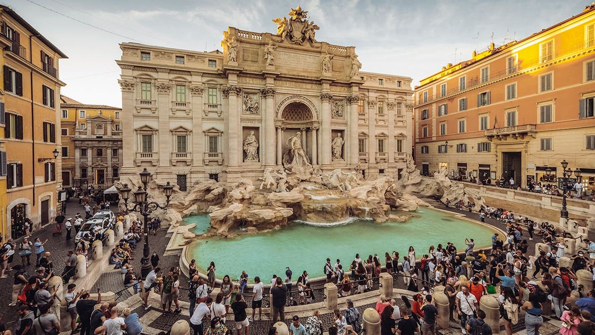 Trevi Fountain with tourists in Rome Italy