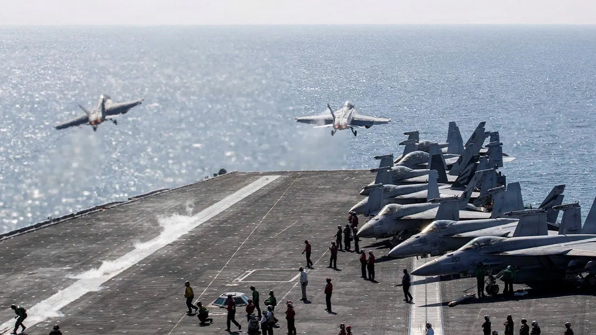 Two F/A-18 Super Hornets launch from flight deck of USS Abraham Lincoln during Operation Epic Fury