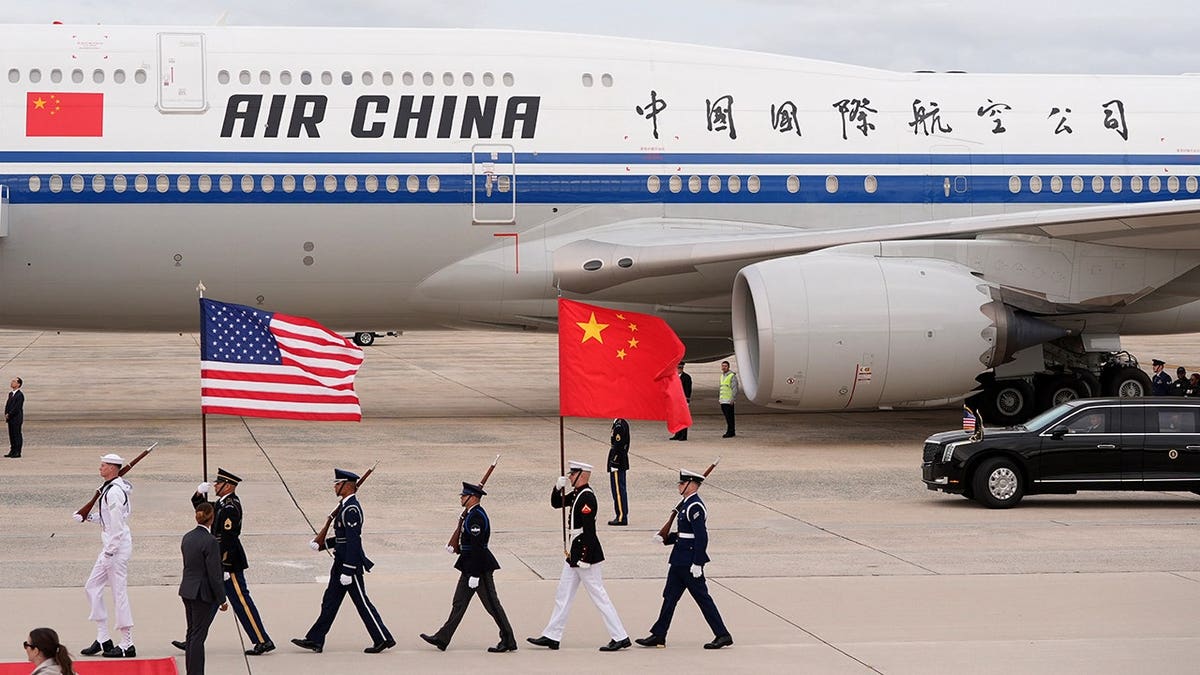 Chinese President Xi Jinping and his wife Peng Liyuan arrive at Joint Base Andrews as flags are marched in.