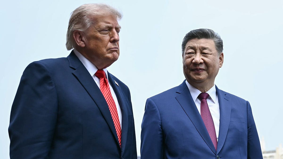 Xi Jinping and Donald Trump walk together at the Temple of Heaven in Beijing, China.
